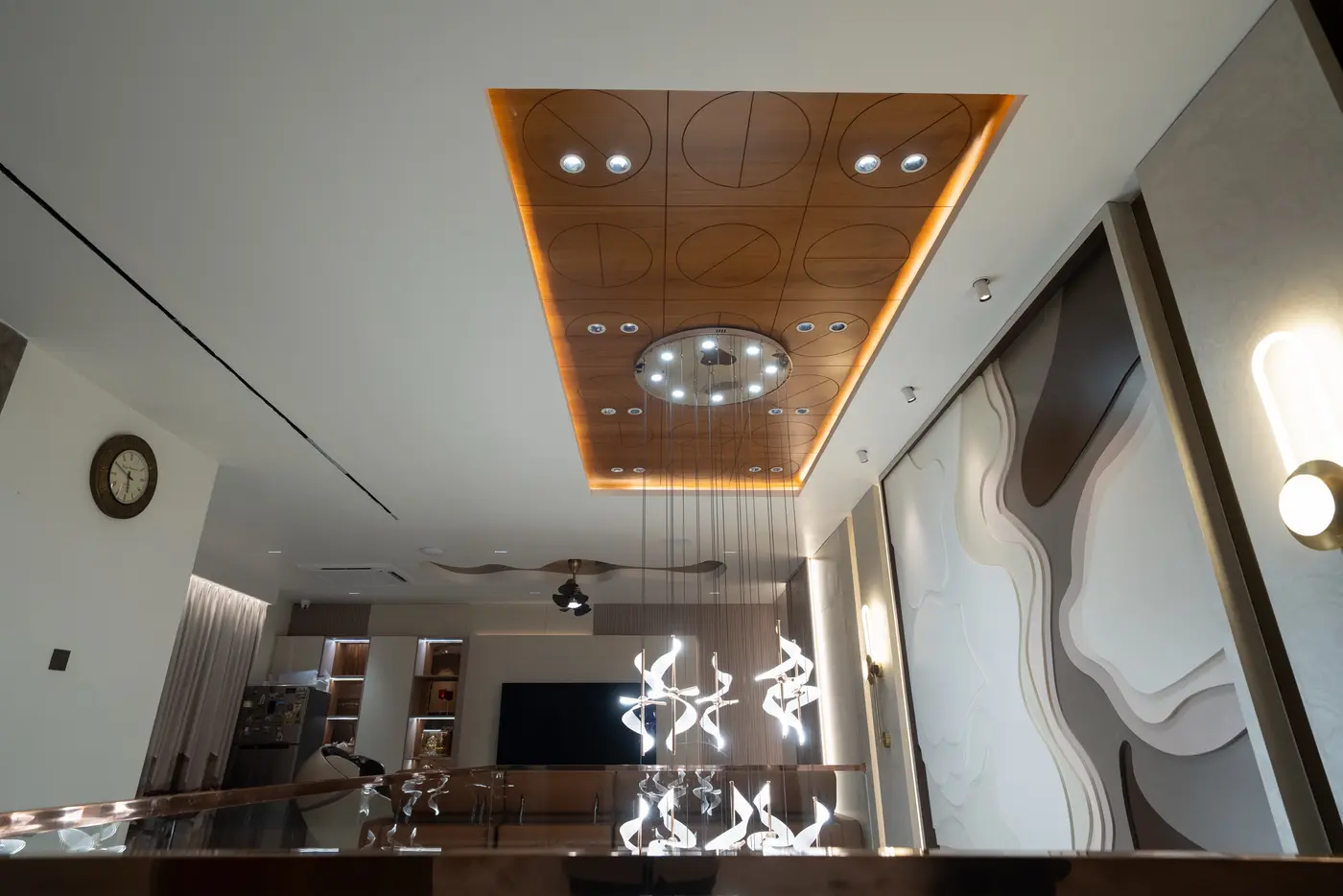 Living room with a large sculpted art wall and a wooden coffered ceiling