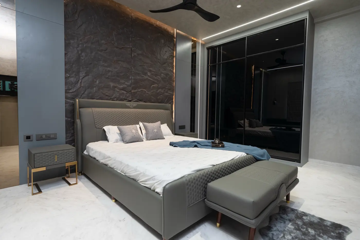 Bedroom with a soft rug anchoring the bed and bench