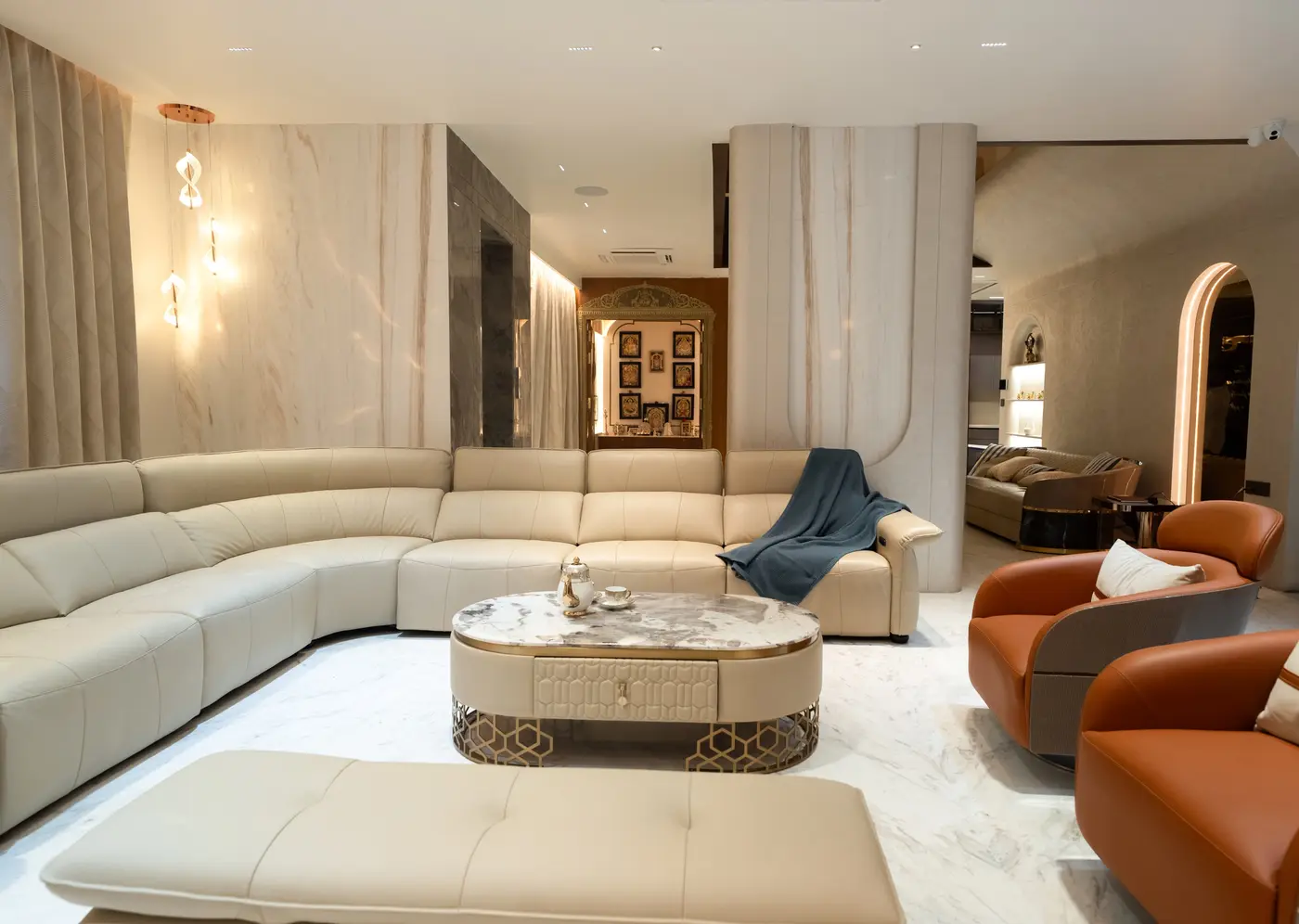 Living room with a curved sectional sofa, oval coffee table and accent chairs, with clear walking space around the seating